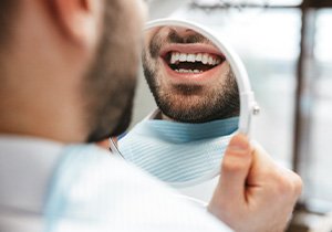 Patient looking at smile in reflection