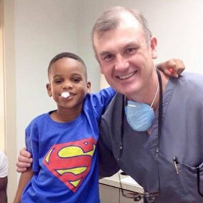 Dr. Hube Parker smiling with a young patient.