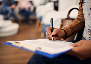 A woman filling out a dental insurance form