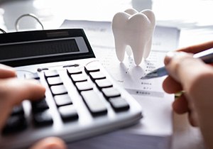 A patient calculating the cost of their dental implants