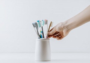 hand reaches for brush in holder