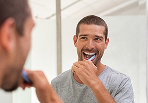 a person brushing his teeth 
