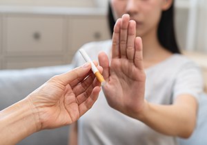 a person rejecting a cigarette 